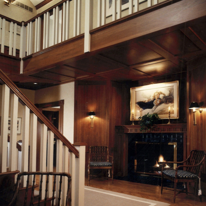 Foyer with cherry paneling and fireplace